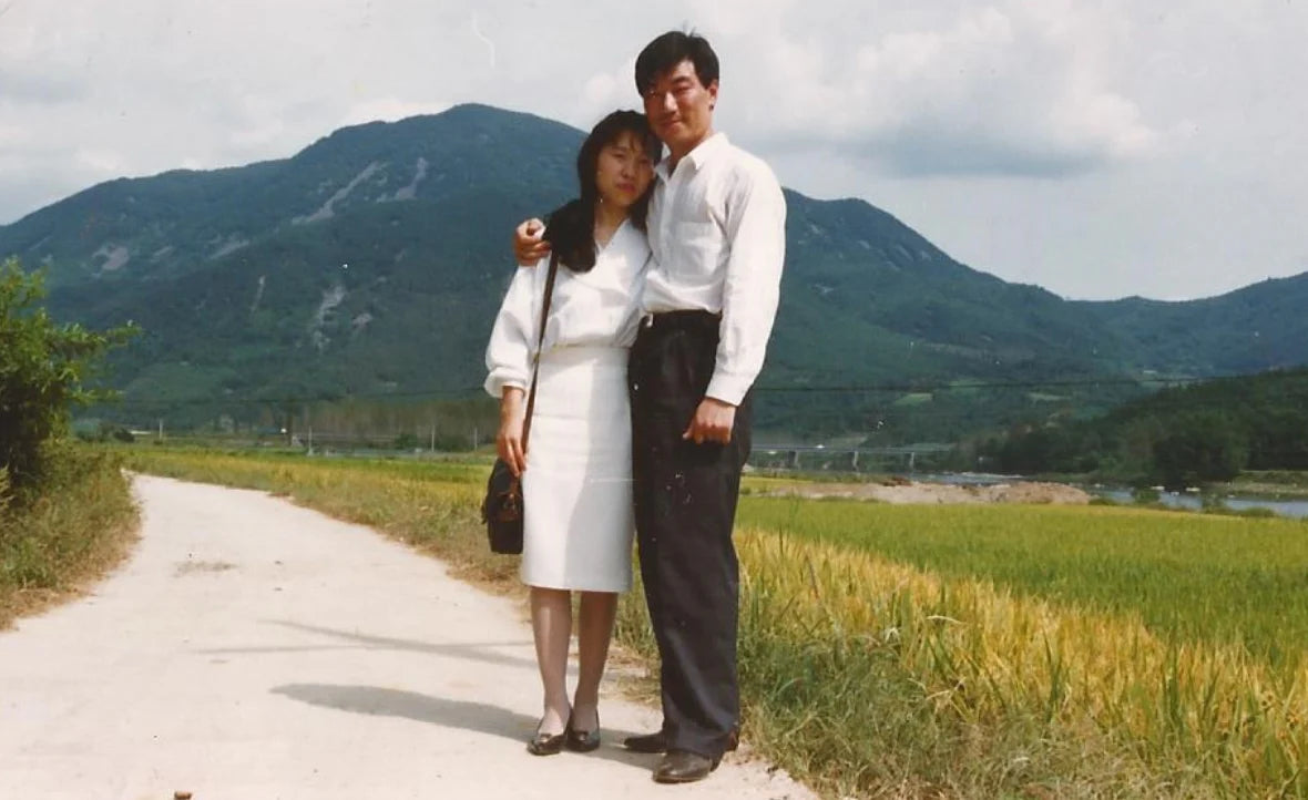 A couple standing together in Korea in the 1990s.