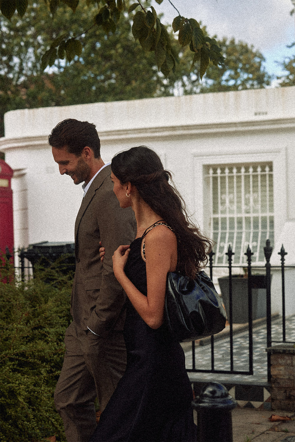 A couple walking together through a residential London neighbourhood.